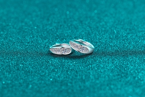 Macro shot of S925 sterling silver hoop earrings with marquise-cut moissanite leaves