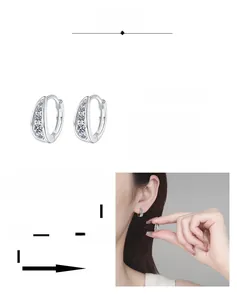 Detail of moissanite U-shaped hoop earrings featuring multiple layers of rhodium plating