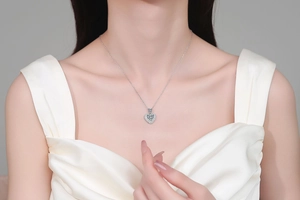 Close-up of S925 sterling silver heart necklace with moissanite pendant on a model