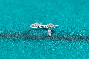 Macro shot of S925 sterling silver ring with wavy pavé stones and marquise pendant