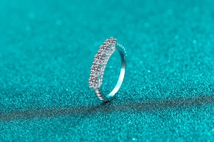 Detailed close-up of a S925 sterling silver ring with five sparkling moissanite stones