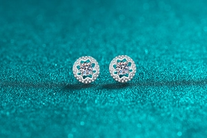 Macro detail of S925 sterling silver moissanite star studs with sparkling halo setting