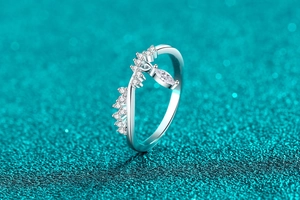 Macro shot of S925 silver wave ring with marquise cut stone on blue glitter background