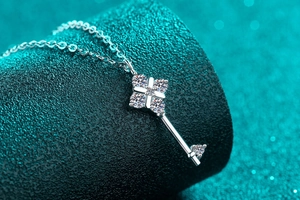 Macro shot of silver S925 sterling silver key pendant with sparkling moissanite stones