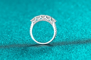 Macro shot of S925 sterling silver band with five brilliant-cut moissanite stones