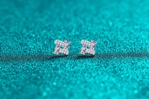 Macro view of S925 silver stud earrings with moissanite in a geometric windmill design