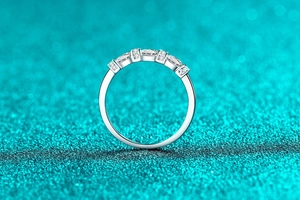 Macro detail of S925 sterling silver ring with five sparkling moissanite stones