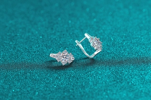 Macro detail of S925 sterling silver moissanite snowflake stud earrings with U-shaped clasp