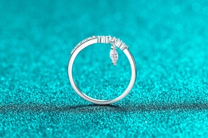 Detail of silver crown ring with marquise cut dangling gemstone and pavé settings