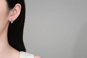 Close-up of S925 sterling silver moissanite U-shaped earrings on model ear lobe