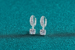 Detail of silver S925 moissanite drop earrings with secure hoop closure and sparkling stones