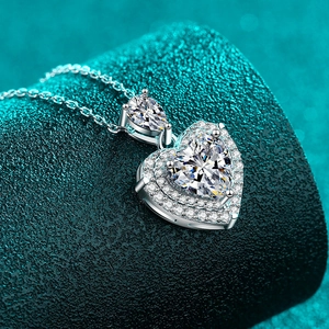 Sparkling S925 sterling silver heart moissanite pendant necklace on blue texture