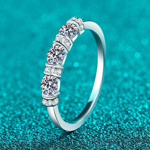 Exquisite S925 sterling silver ring with three oval moissanite stones on sparkling blue background