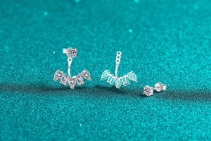 Macro shot of S925 silver moissanite ear jackets with marquise and round cut blue stones