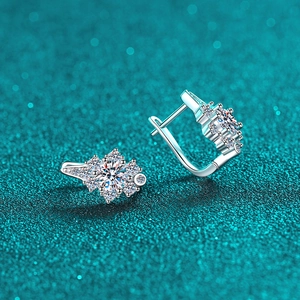 Elegant S925 sterling silver moissanite huggie earrings with snowflake design on blue background