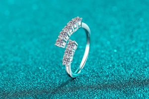 Detail of S925 sterling silver ring featuring seven round moissanite stones in a row