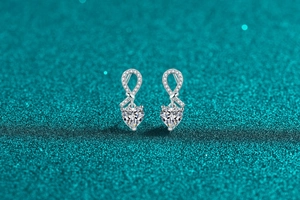 Macro shot of S925 sterling silver heart earrings with moissanite in a ribbon design