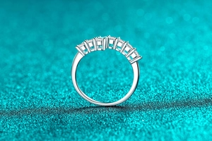 Detail of S925 sterling silver ring with seven prong-set round moissanite stones