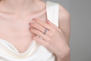 Close-up of modern S925 sterling silver ring with blue pavé stones worn by a model