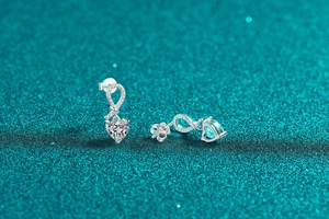 Macro shot of S925 sterling silver bowknot heart earrings with moissanite accents