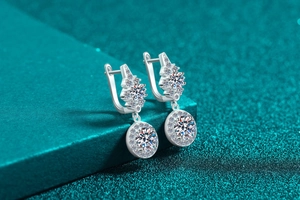 Macro shot of 925 silver moissanite earrings with geometric pave setting and round stone