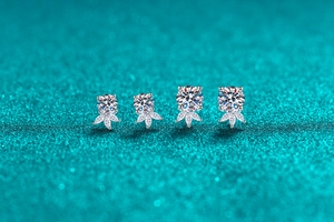 Macro view of floral S925 sterling silver moissanite stud earrings in two different sizes
