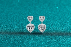 Detail of silver S925 heart drop earrings with sparkling moissanite stones and pavé setting