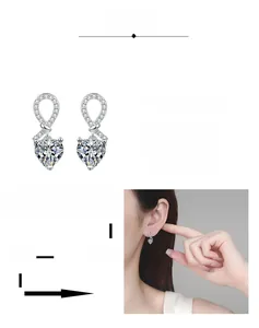 Detail of S925 silver heart moissanite earrings showing infinity knot and model fit