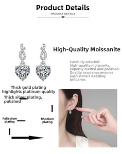 Detail of heart-shaped moissanite earrings showing multi-layer plating and ear styling
