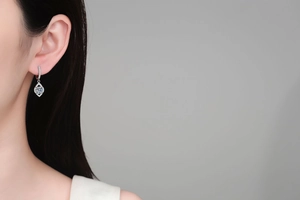 Detail of S925 sterling silver teardrop earrings with moissanite on a model