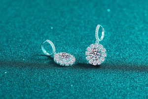 Close-up of S925 sterling silver sunflower earrings with sparkling moissanite stones