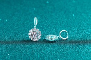 Macro shot of S925 sterling silver moissanite sunflower earrings on glittery background