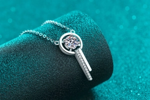 Macro shot of S925 silver necklace with moissanite pendant on a green pedestal