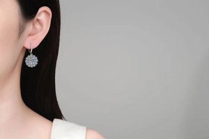 Detailed view of S925 sterling silver sunflower moissanite earring on a model