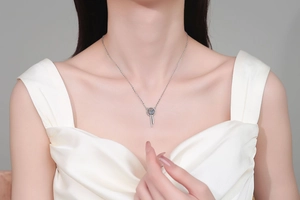 Detail of S925 sterling silver moissanite tassel pendant necklace on a model