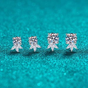 Sparkling S925 sterling silver moissanite stud earrings in two sizes on green background
