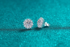 Macro shot of silver sunflower stud earrings with sparkling moissanite petals