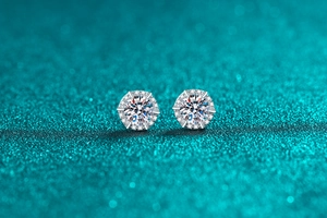 Macro shot of S925 sterling silver halo stud earrings with six-prong moissanite setting