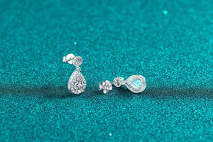 Macro detail of pear-shaped moissanite drop earrings with S925 sterling silver halo setting