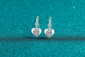 Macro shot of S925 silver heart earrings featuring large heart-cut moissanite stones