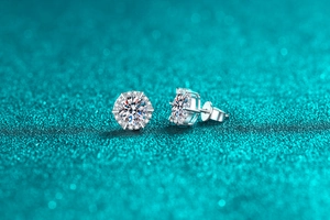 Macro shot of S925 silver moissanite stud earrings featuring classic six-prong setting