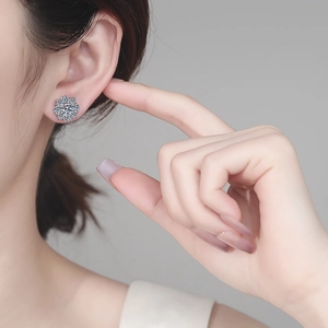 Sparkling S925 sterling silver moissanite flower stud earrings worn by female model