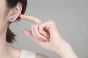 Close-up of S925 sterling silver moissanite stud earring worn on model's ear