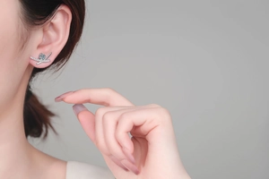 Close-up of S925 sterling silver moissanite stud earring worn on a female model