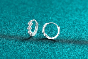 Macro view of sterling silver lightning bolt hoop earrings with shimmering clear stones