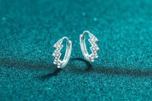 Macro shot of silver 925 lightning wave earrings with sparkling white moissanite stones