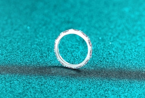 Macro view of S925 sterling silver eternity band with emerald cut moissanite stones