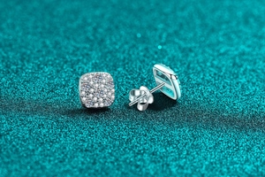 Macro shot of square S925 sterling silver stud earrings with pavé moissanite setting