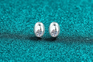 Macro shot of S925 sterling silver oval stud earrings featuring sparkling moissanite stones