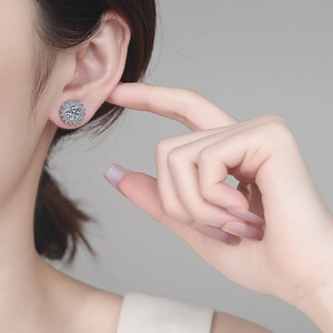 Sparkling S925 sterling silver sunflower moissanite stud earrings worn by a model